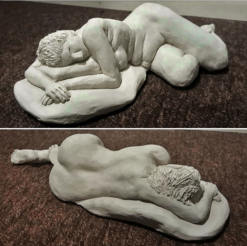 Reclining clay figure sculpture